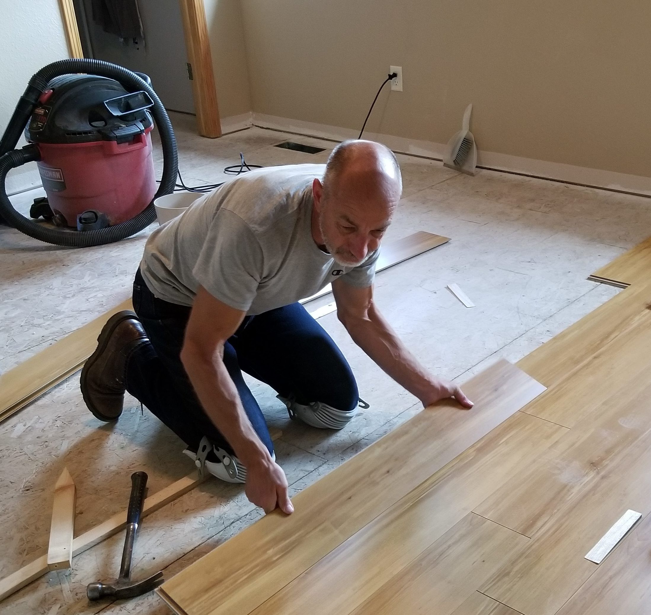 Dean Henderson, owner of Blue Ladder Construction installing a new bedroom floor in Rapid City.
