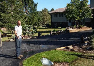 Photo of completed driveway, sod, and drainage.