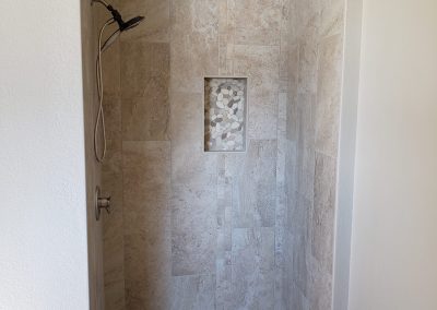 Photo of a master bathroom tiled shower.