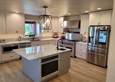 Remodeled kitchen island with oven and prep sink.