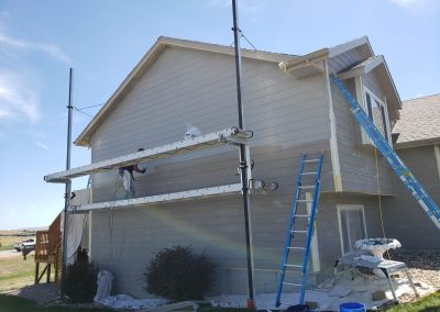 Photo of exterior painting in progress.