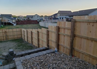 Photo of stepped cedar privacy fence.