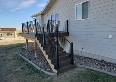 Photo of a Trex Deck with black fortress railing and stairs.