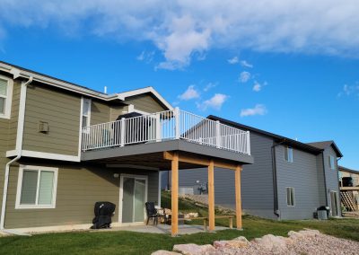 Photo of second story deck with large cedar post and notched beam.